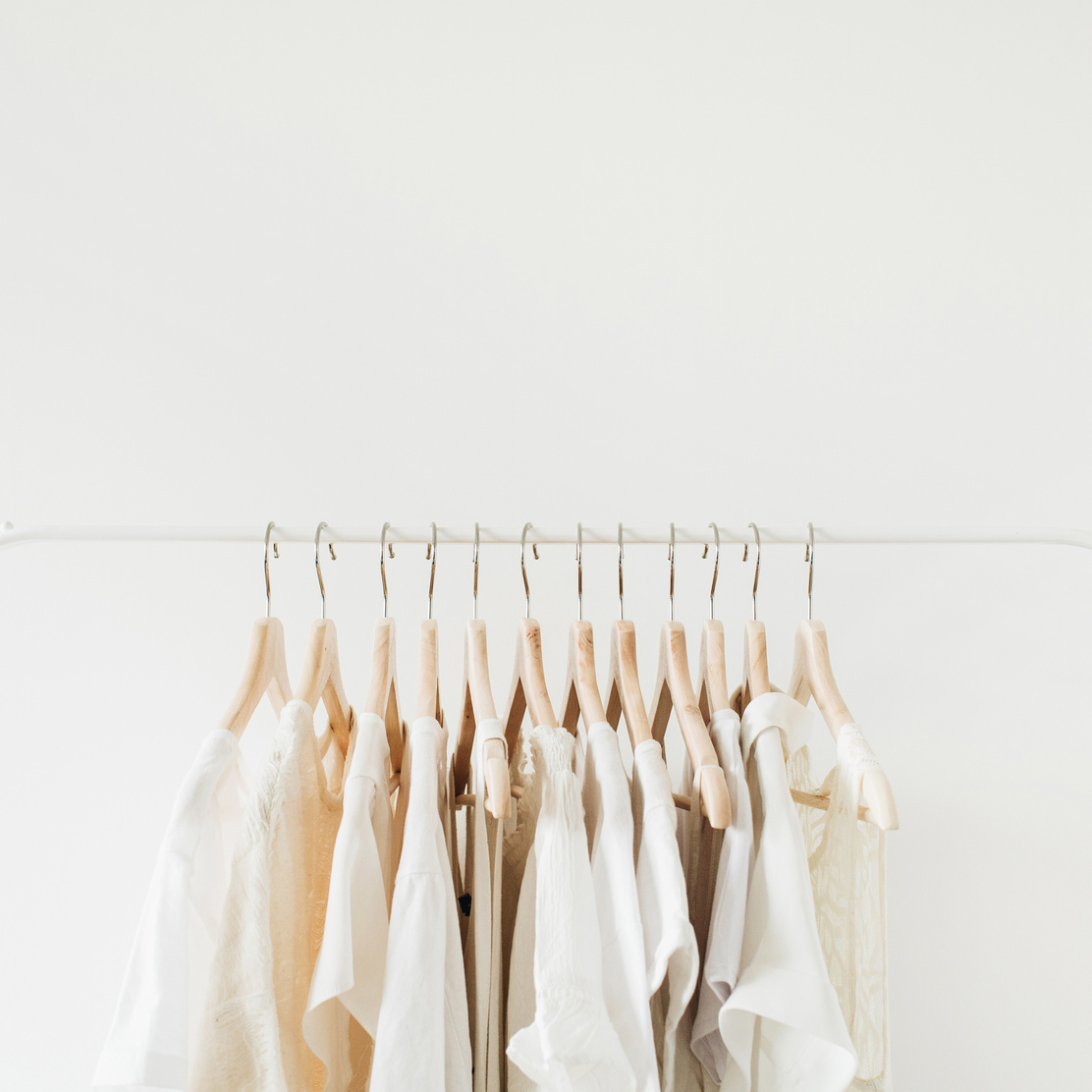 White Clothes Hanging on Rack